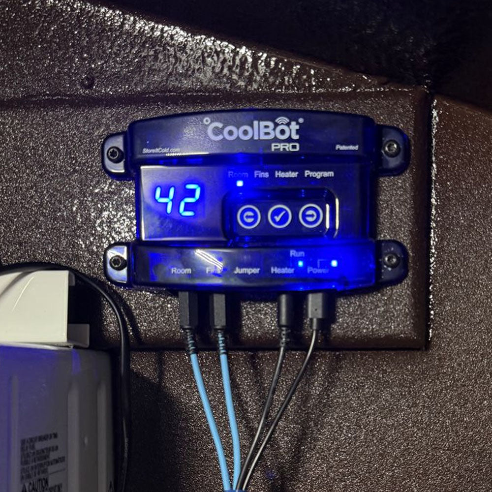 CoolBot Pro power control unit with a blue LED display showing '42' and connection wires plugged into three ports, mounted on a textured brown surface.