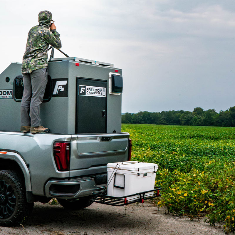 Scouting for whitetails overlooking the hunting camper