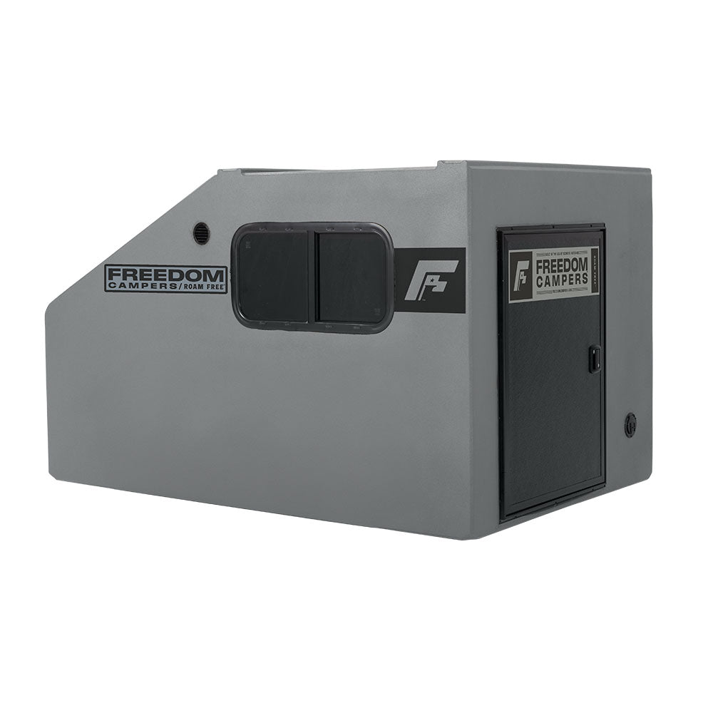 Angled view of the gray Freedom Camper showing the horizontal window and door.