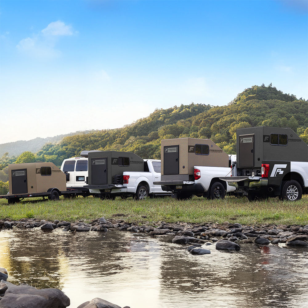 Line of Freedom Campers along a stream in the mountains
