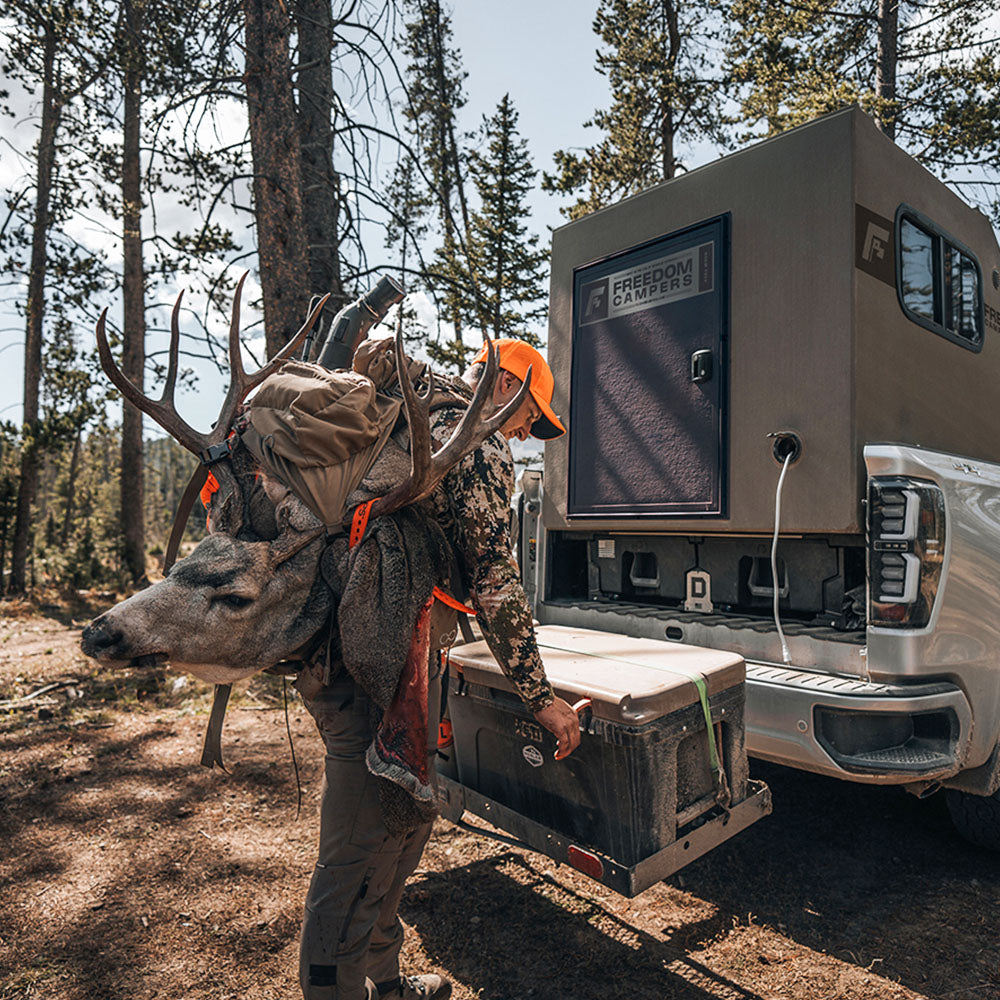 Hunter loading up gear at Freedom Camper
