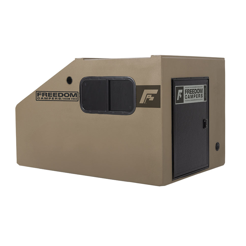 Angled view of the tan Freedom Camper showing the horizontal window and door.