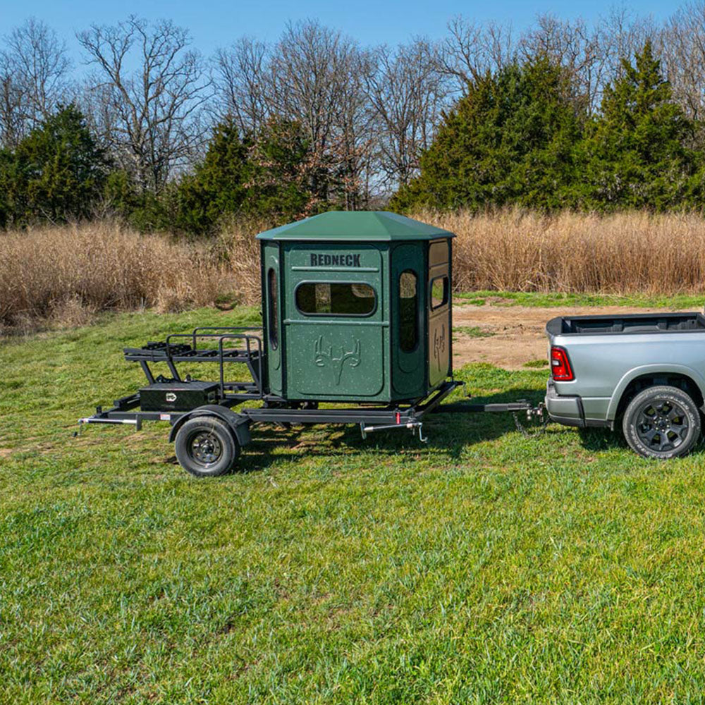 Tuck towing the portable Hydraulic Deer Blind Trailer from Redneck Blinds into a food plot.